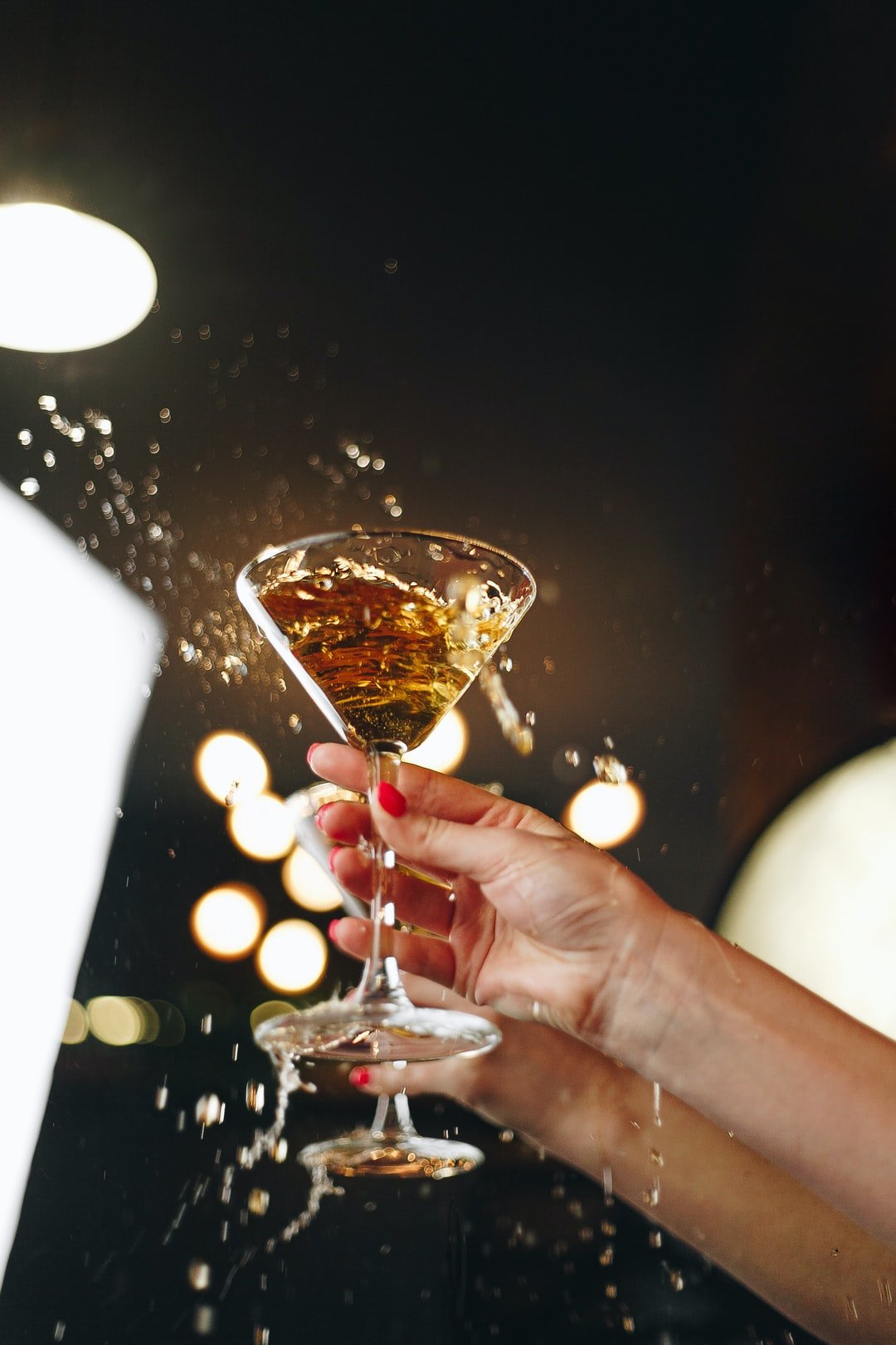 person holding clear wine glass